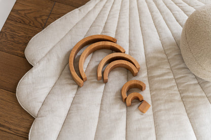 Detailed quilting and stitching on the sand-colored linen shell playmat