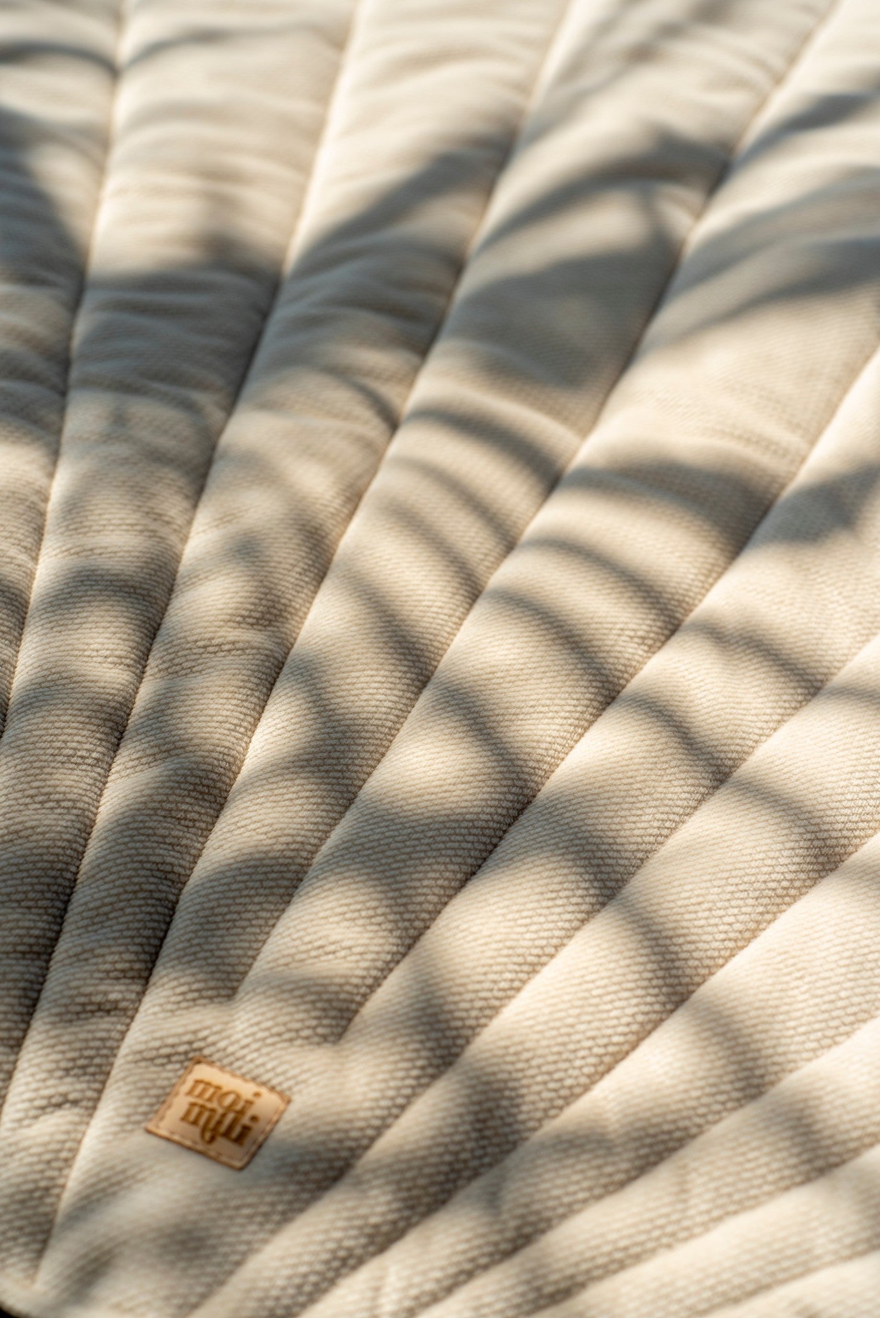 Detailed quilting and vein stitching on the luxurious beige velvet shell mat