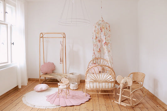 Elegant nursery: Powder Pink velvet shell mat on a wooden floor next to a white canopy