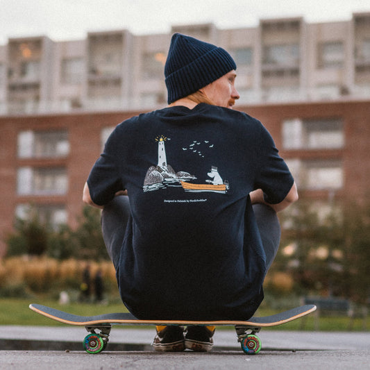 Official Moominpappa Premium Navy T-Shirt by Nordicbuddies, back print shown by a model on a skateboard.