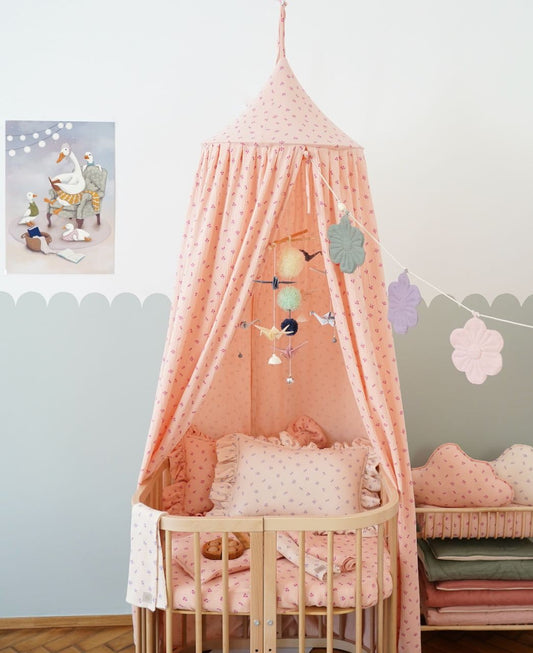Nursery decor: Pastel Colors origami mobile hanging above a white wooden baby crib