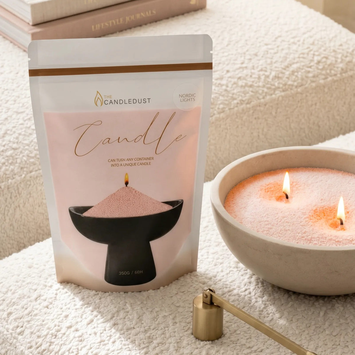 Lit Peach pearled sand candle displayed on a decorative tray resting on an elegant sofa 