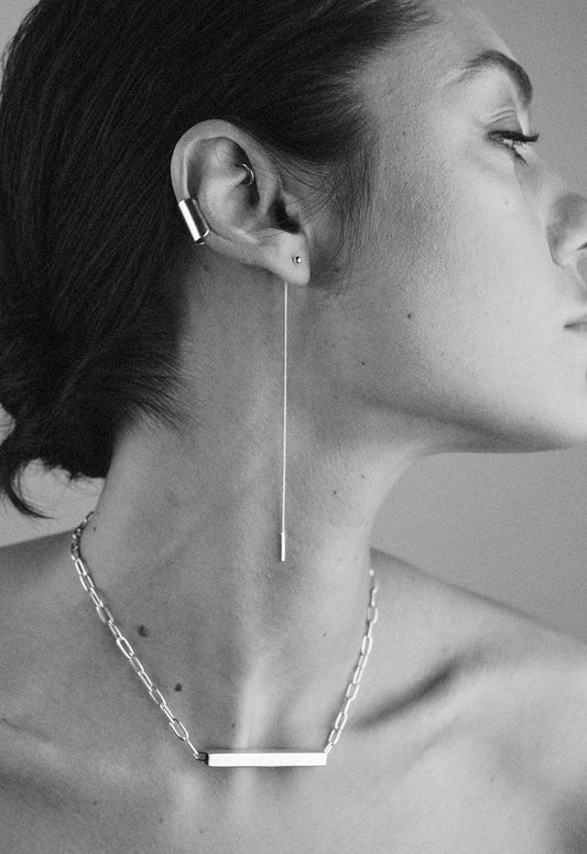 Woman highlighting the handmade silver Pin Up Threader Chain Earrings.