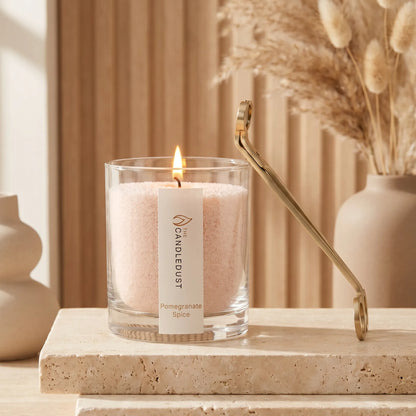 Modern minimalist interior styling featuring an unlit Pomegranate Spice scented glass candle displayed on a stone slab