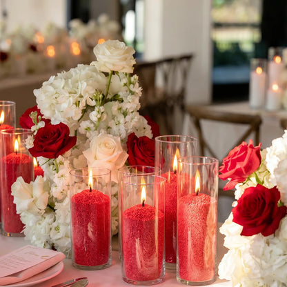 Elegant dining table beautifully set for a dinner party with a glowing Red glass sand candle 