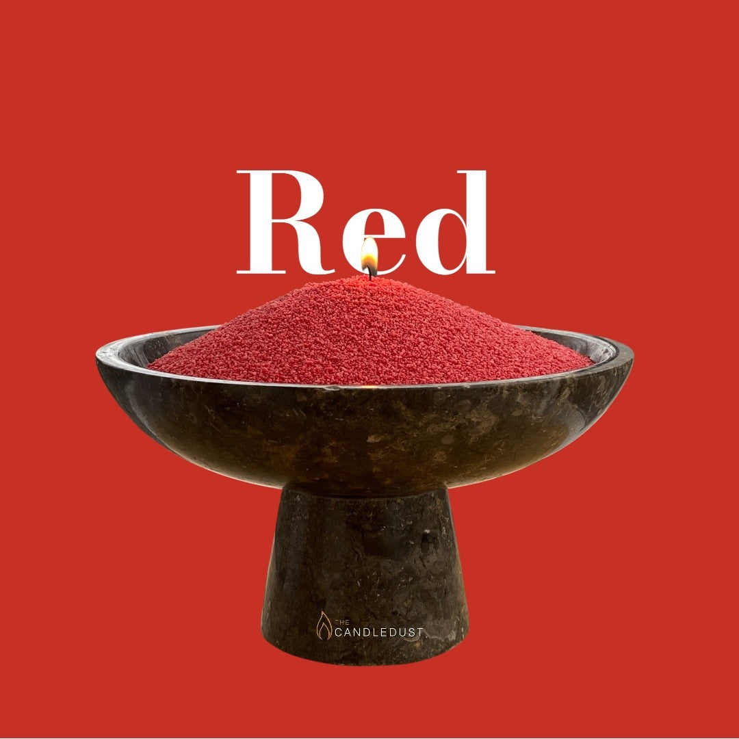 Red text on a matching bold red background with a glass vase full of unlit pearled candle sand in the foreground
