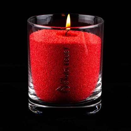 Lit Candledust Red unscented pearled candle in a 160g glass jar with cotton wick on a black background