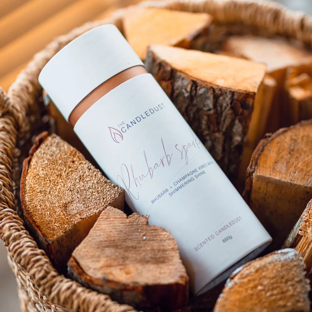 Candledust Rhubarb Sparkle scented pearled candle sand in a 650g cylinder tube on wooden logs