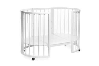 KOTTO Olin space-saving round baby crib in a clean white finish with wheels