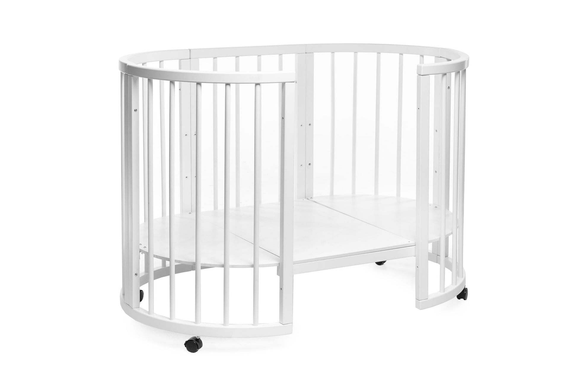Complete transforming nursery setup featuring the Olin round bed and mattress with wheels