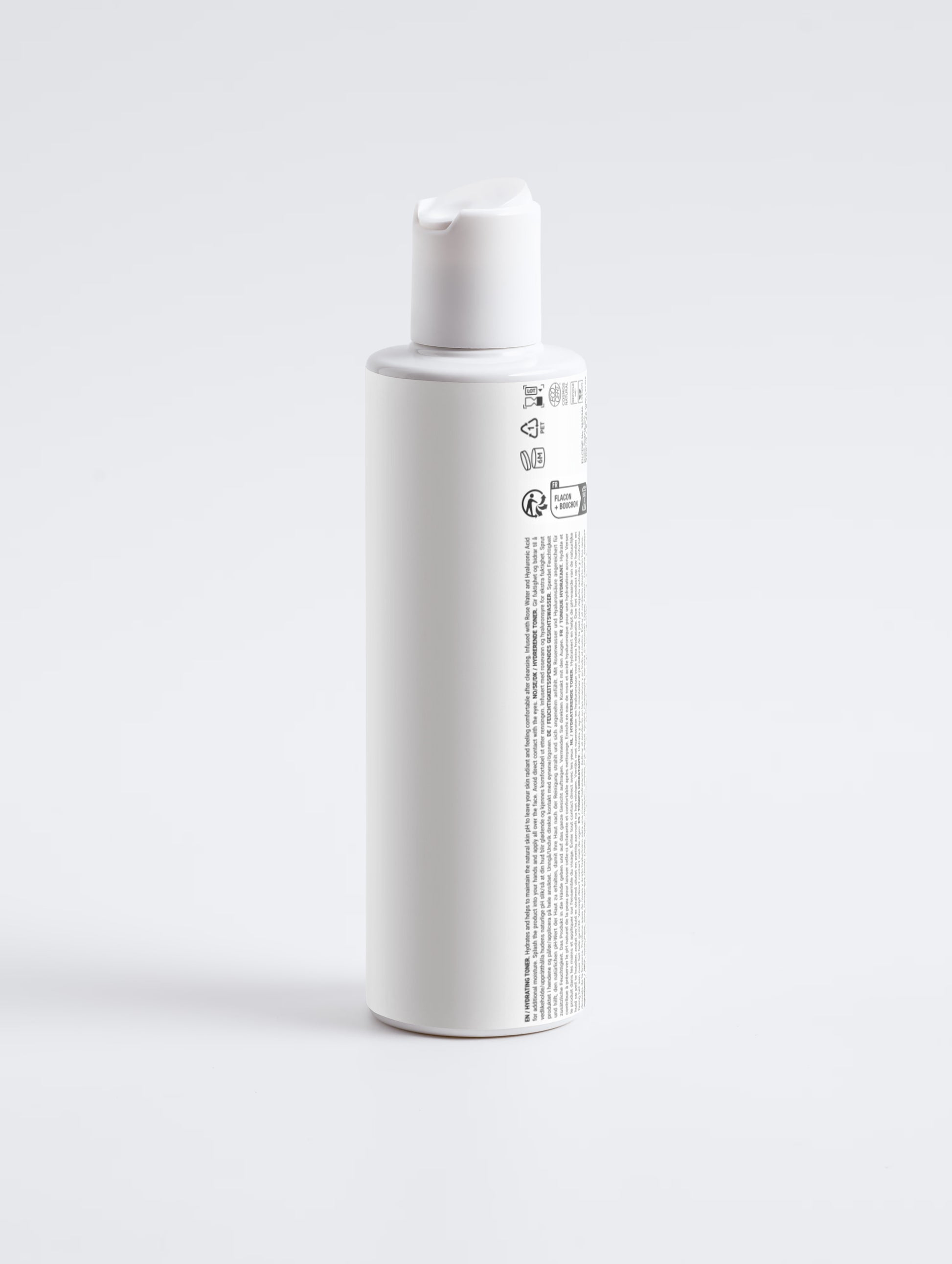 A tall, white cylindrical bottle with a matching white cap, shown from a side angle on a seamless light gray background. The bottle features a white label with black text and regulatory symbols.