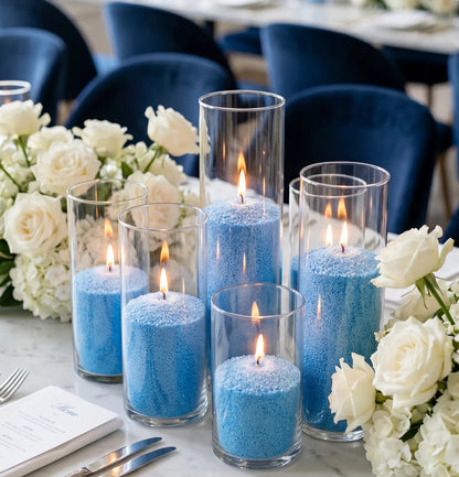 Elegant dining table beautifully set for a dinner party with a glowing Sky Blue glass sand candles