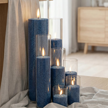Glass vases of various heights filled with burning Space Grey pearled candle sand creating a glowing cluster