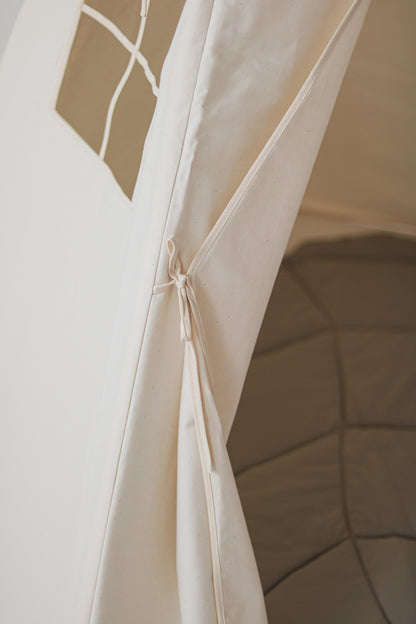 Nursery detail: close-up of the beige cotton tie-backs used to keep the teepee tent entrance open and inviting
