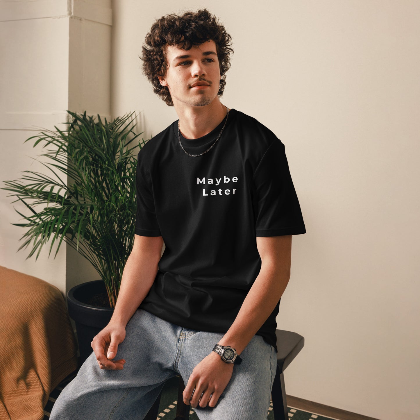 View of a male model wearing the unisex Maybe Later vegan tee. black