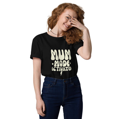 Woman wearing a black organic cotton t-shirt with the vintage cream MUM MODE ACTIVATED graphic, looking confident.