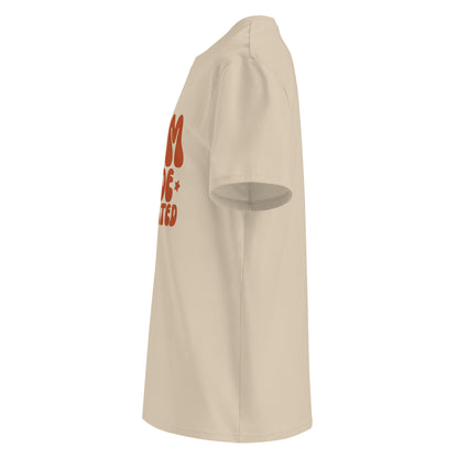 Side view of Trendy sand beige mom t-shirt with a groovy MUM MODE ACTIVATED graphic in terracotta red, designed for an eco-friendly boutique look.