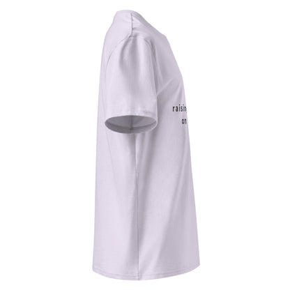 Side view of the "raising humans on plants." t-shirt being worn, showcasing the comfortable unisex fit and the softness of the eco-friendly material. -lavander-