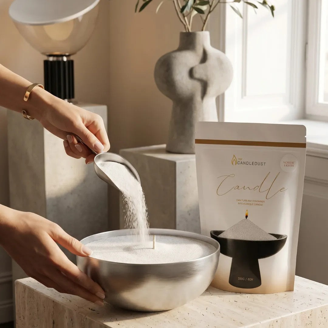 Woman filling large metal candle holders with White natural pearled candle sand