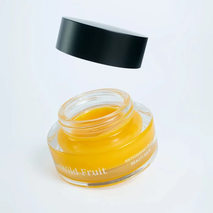 Usva Wild Fruit balm with opened lid on a white background